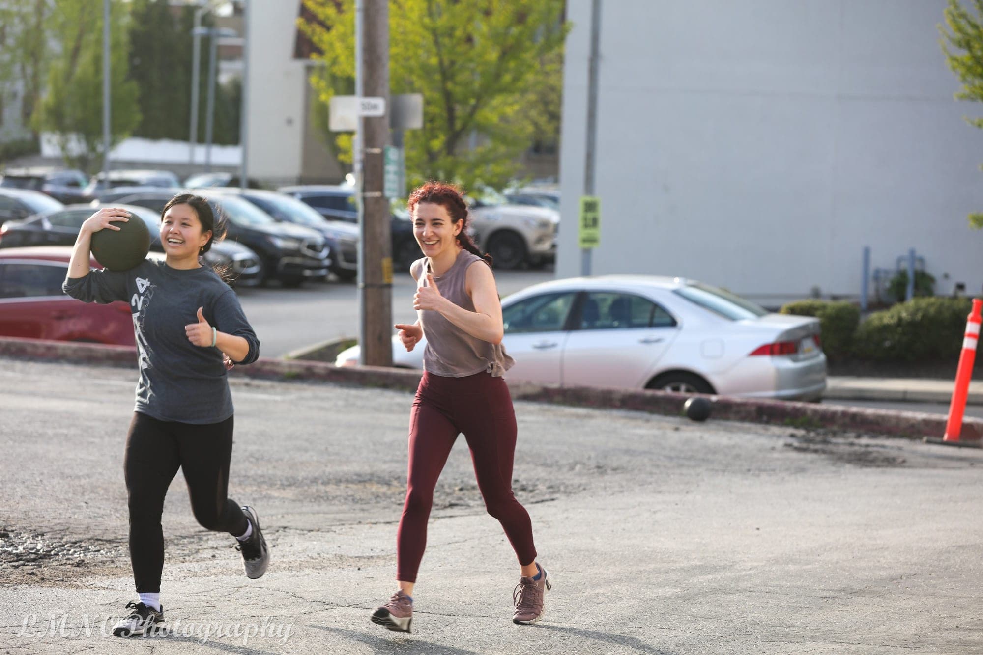 Members running with a medicine ball during a conditioning workout