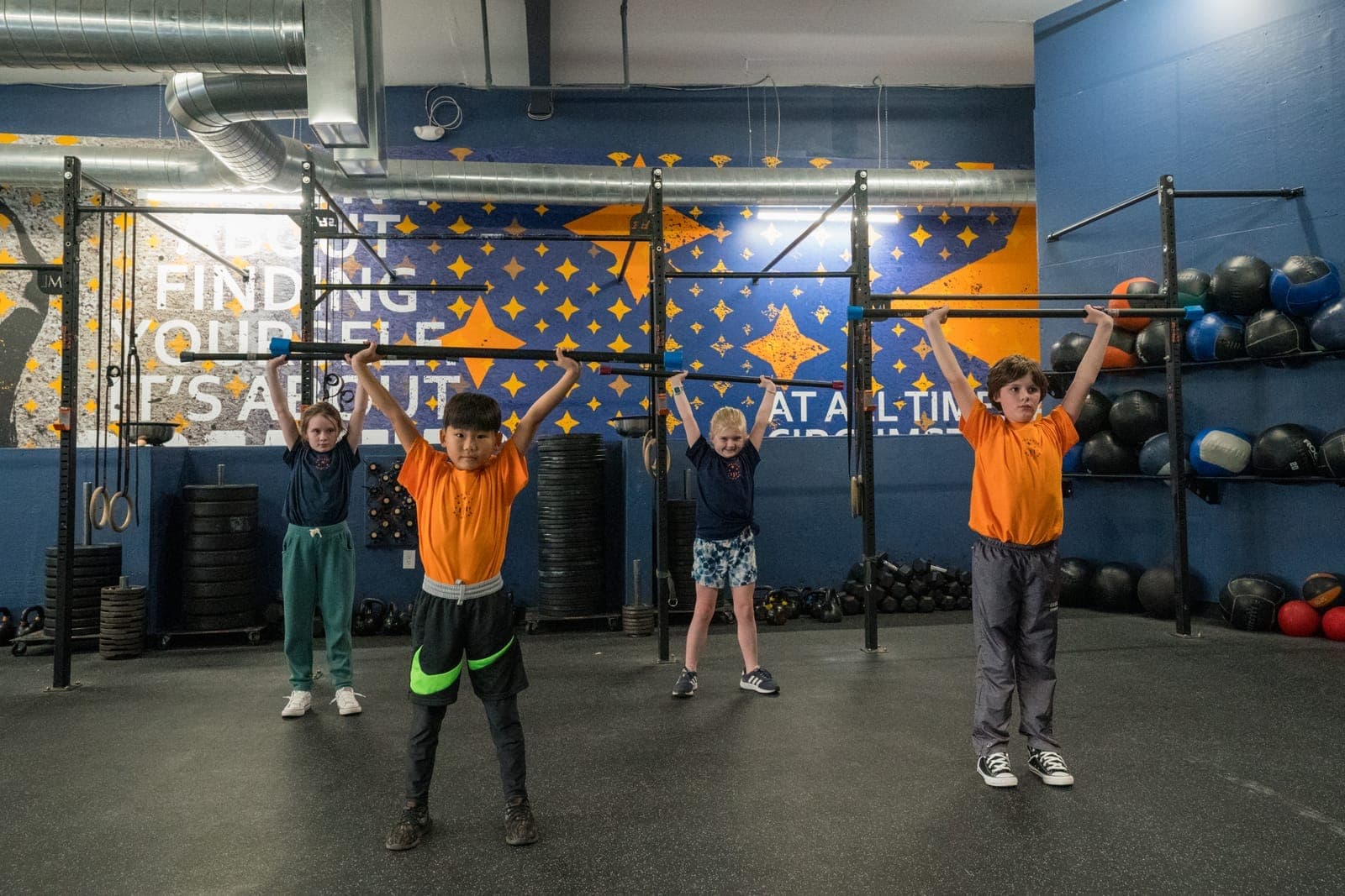 Kids warming up together at the start of a youth class at CrossFit Main Line